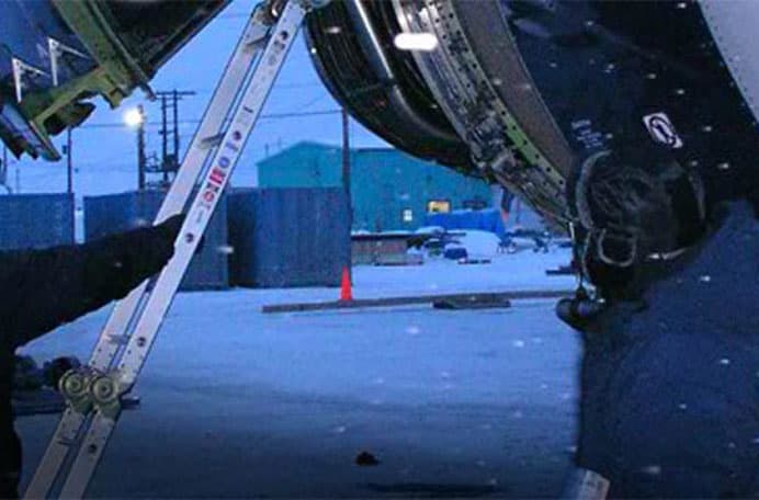 Service team working on an aircraft in the winter