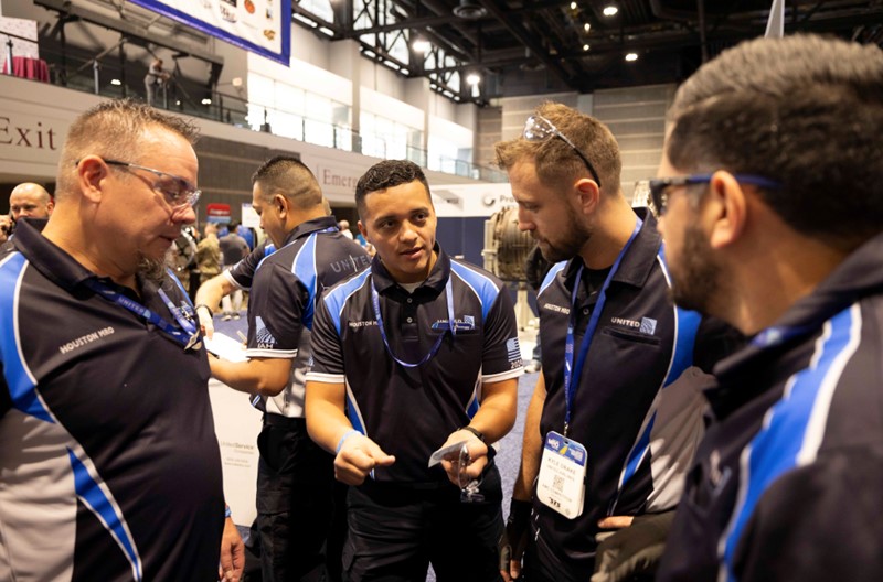 Base team’s IAH Line Technician Kevin Leonel Pineda discussing an upcoming event with teammates