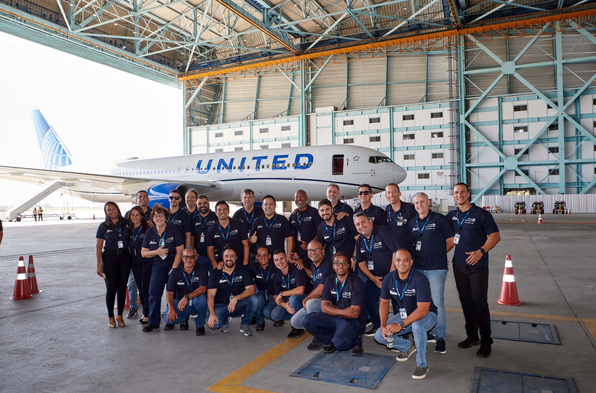 Tech Ops GIG group photo in front of plane