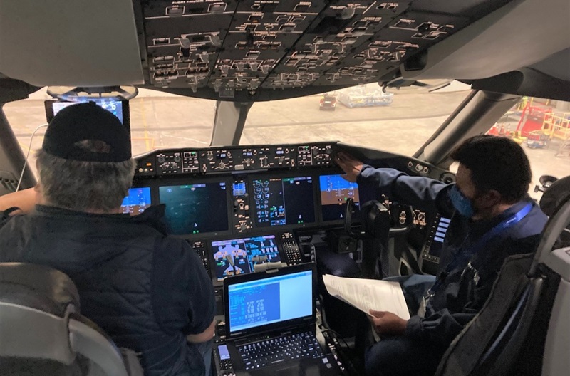 Jay Juman in flight deck of 787 in hangar